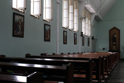 Empty chairs and table in building