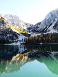 Scenic view of lake and mountains against clear sky