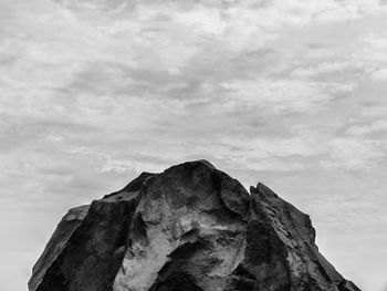 Low angle view of cliff against sky