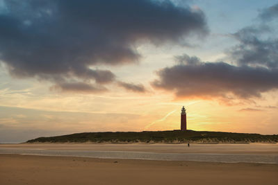 Scenic view of beach against sky during sunset