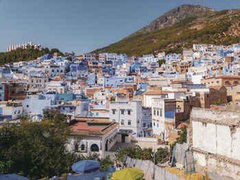 Houses in town against clear sky