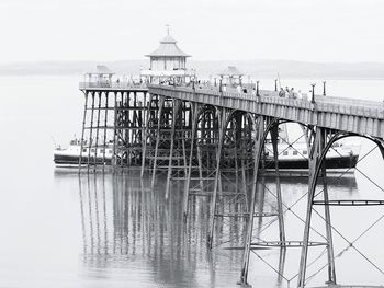 Ship by clevedon pier in sea against sky