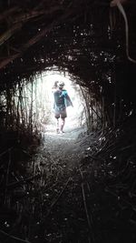 Full length of woman walking in forest