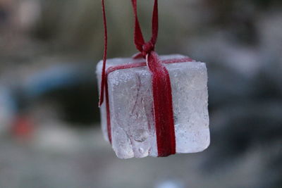 Close-up of ice cream hanging on metal during winter