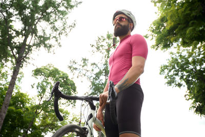 Low angle view of man riding bicycle against sky