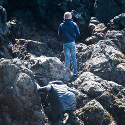 Rear view of man standing on rock