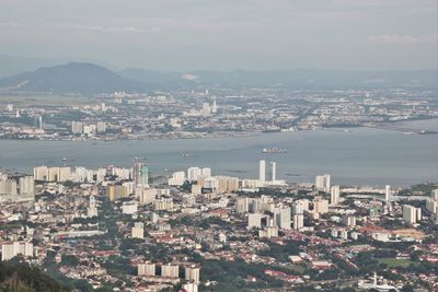 High angle view of town by sea against sky