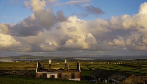 Houses on field against sky