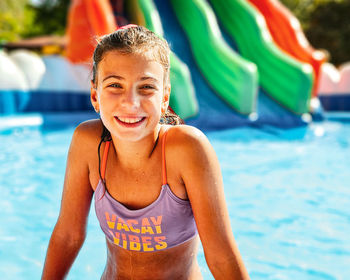 Portrait of young woman swimming in pool