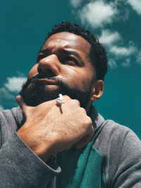 Portrait of young man smoking outdoors