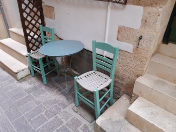Empty chairs and table crete