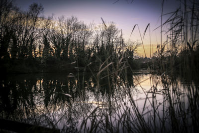 Scenic view of lake against sky at sunset