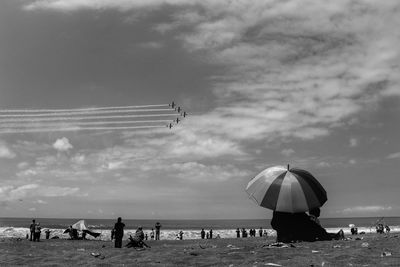 Airshow against sky over beach