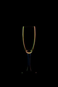 Close-up of wineglass against black background