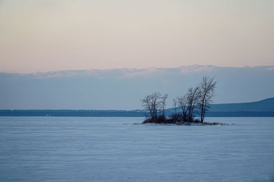 Scenic view of snow covered landscape against sky during sunset