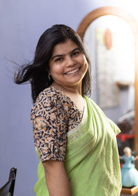 Portrait of a beautiful indian woman in green saree