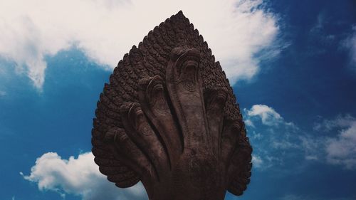 Low angle view of naga statue against sky