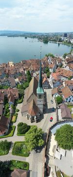 High angle view of townscape by sea against sky