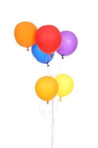 Low angle view of balloons against white background