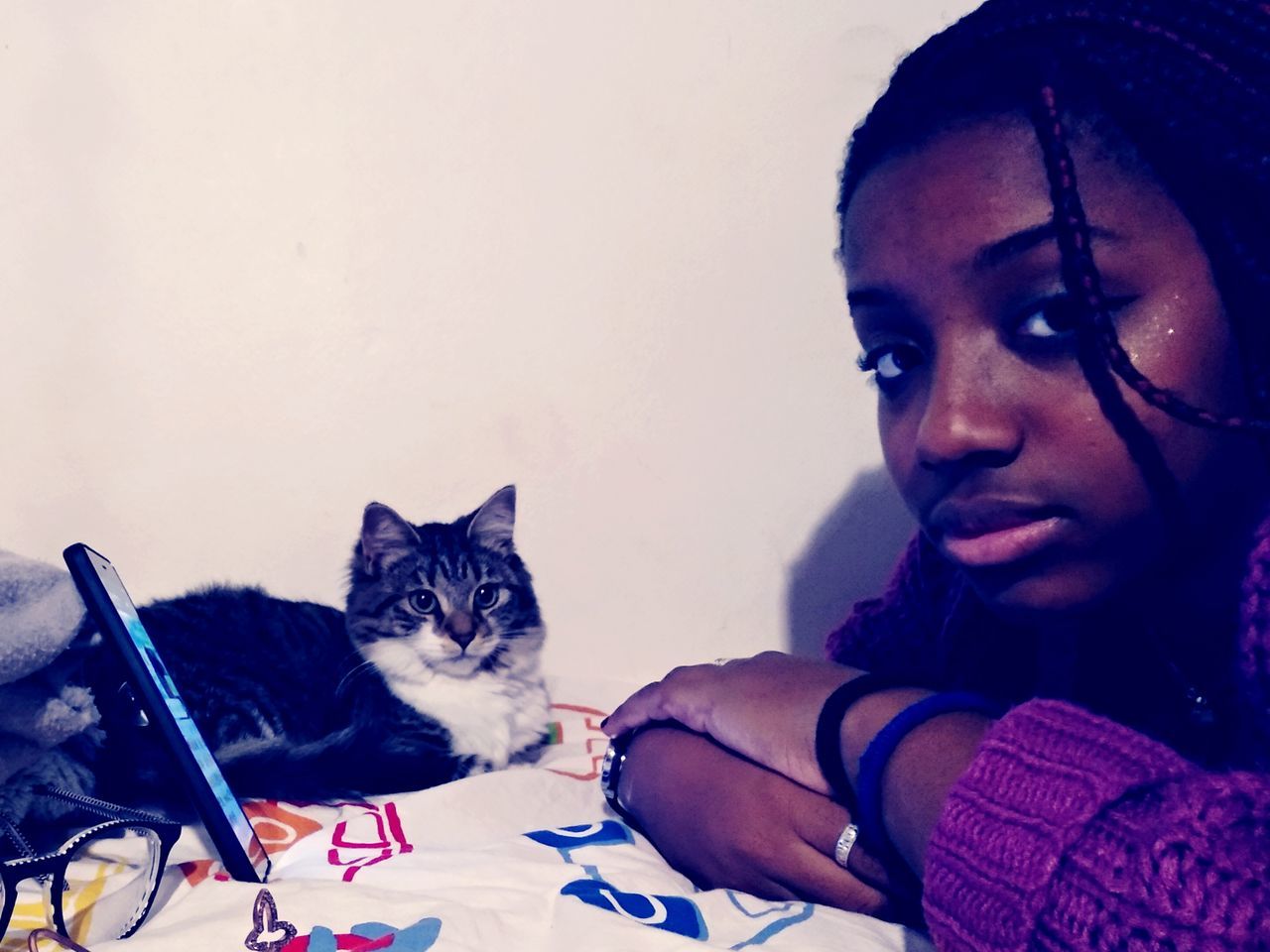 PORTRAIT OF WOMAN WITH CAT AGAINST WHITE BACKGROUND