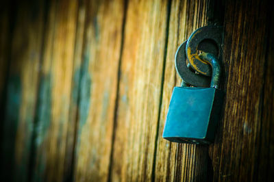 Close-up of metallic door on wood