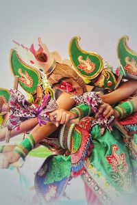 Midsection of people in traditional clothing dancing outdoors