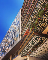 Low angle view of modern buildings against clear blue sky