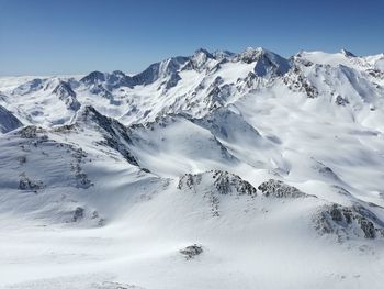 Scenic view of snowcapped mountains against clear sky