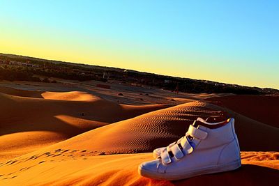 Sand dune in desert against clear sky