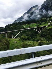 Scenic view of bridge over mountain against sky