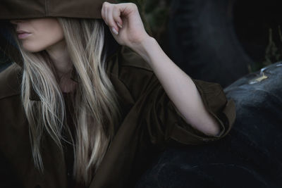 Portrait of a woman in a hood and brown raincoat