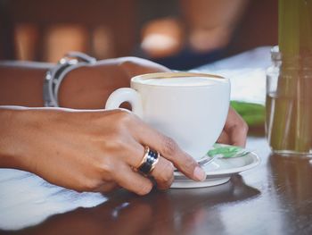 Close-up of hand holding coffee cup