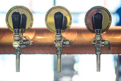Row of draft beer tab on the top of counter bar in closeup view, time of celebration.