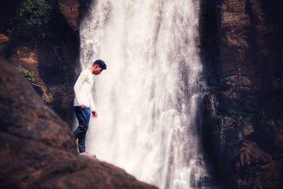 Side view of person standing on rock