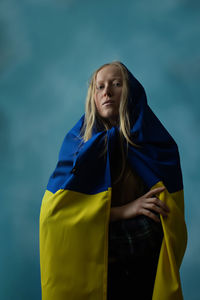 Young woman with ukrainian flag on head