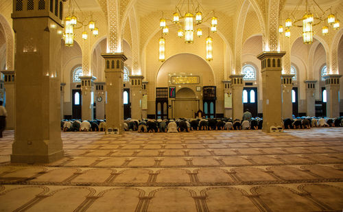 Group of people worshipping in illuminated building