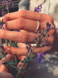 Close-up of woman hand with flowers