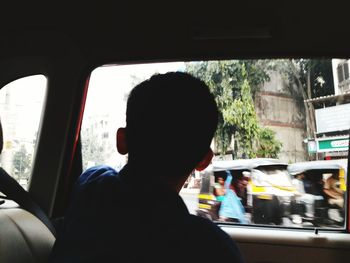 Rear view of man sitting in car