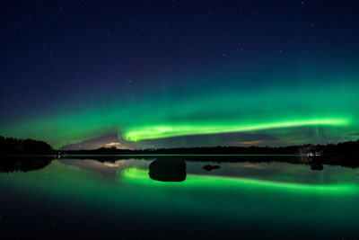 Scenic view of lake against sky at night