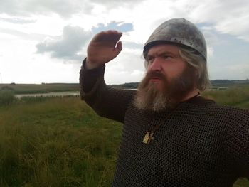 Man standing on field against sky