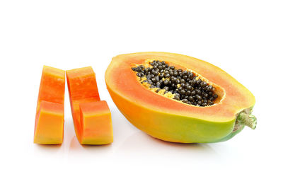 Close-up of orange fruit against white background