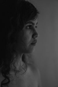 Portrait of young woman against white background