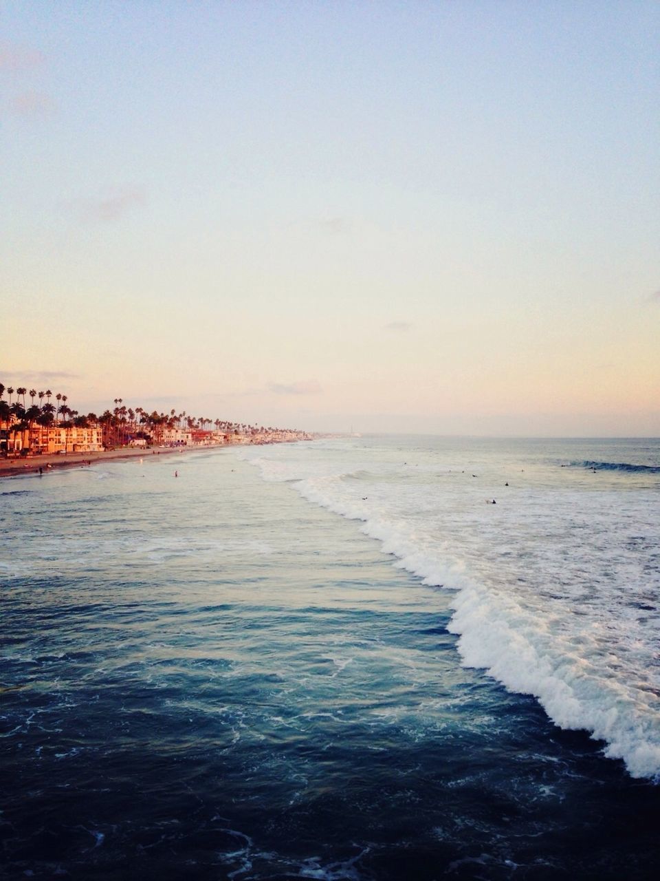 sea, water, horizon over water, scenics, tranquil scene, pier, beauty in nature, wave, beach, tranquility, sunset, sky, nature, surf, shore, idyllic, rippled, waterfront, clear sky, copy space