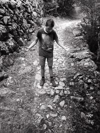 Woman standing on footpath