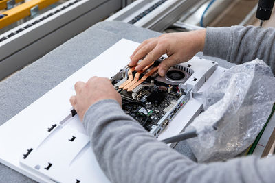 Hands of electrician working at desk