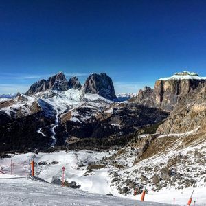 Scenic view of snowcapped mountains against clear blue sky