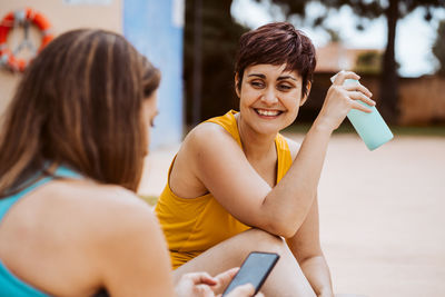 Portrait of young woman using mobile phone