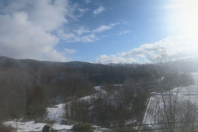 Scenic view of snow covered land against sky