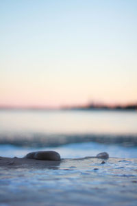 Surface level of sea against clear sky