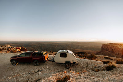 Teardrop camper rv and red pickup truck parked at desert view, utah